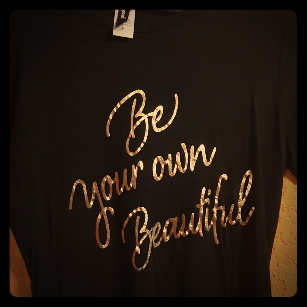 Black large shirt with gold letters.